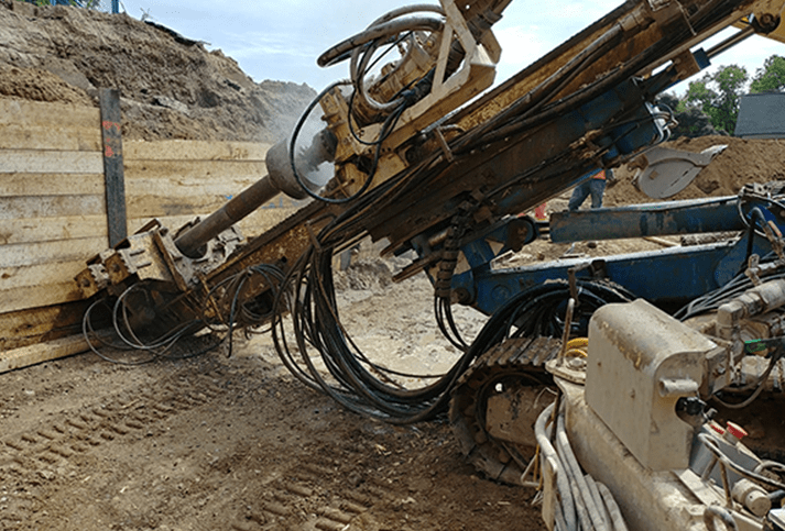 Drilling Rig Attached to Backhoe